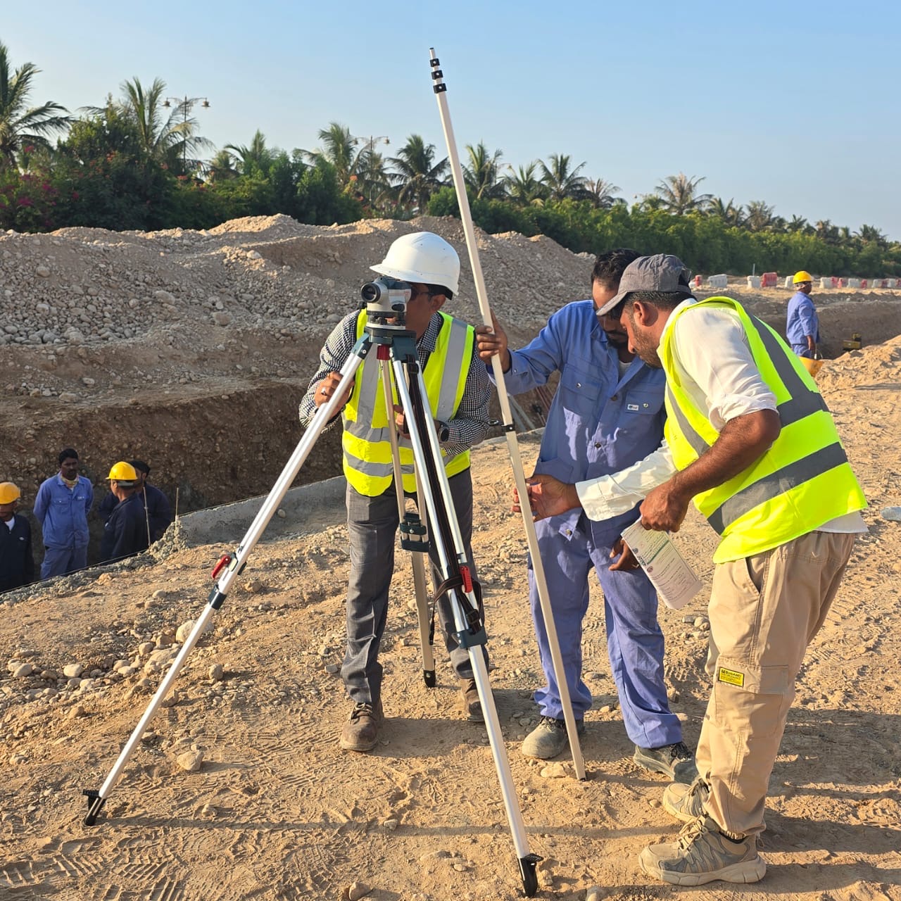 IMS engineers and site team surveying together on a project site